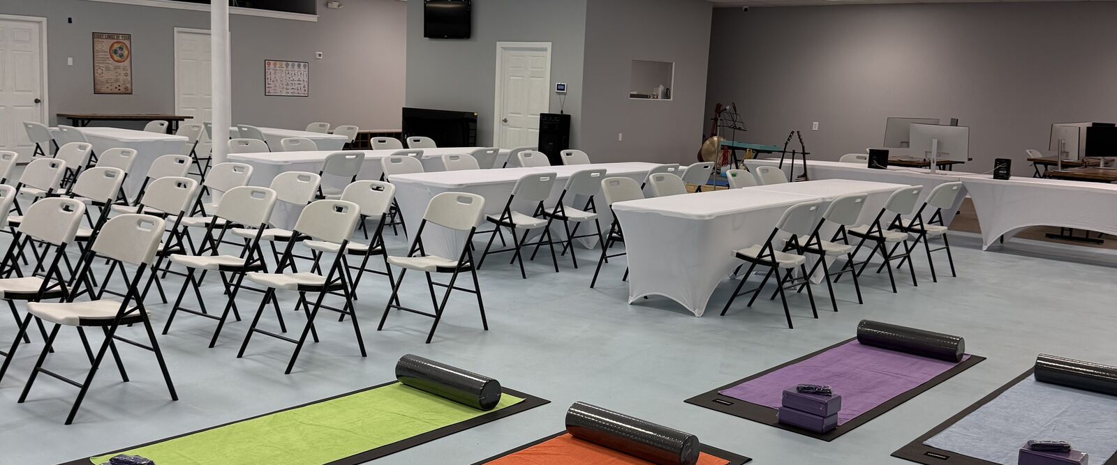 Yoga mats with props set up in a large event room